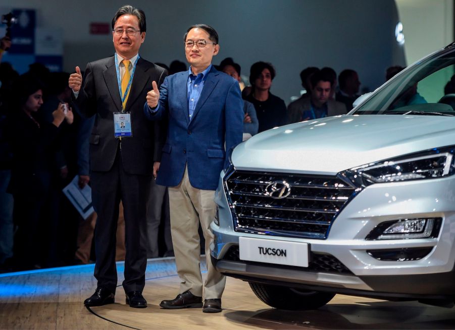 Managing Director (MD) and CEO of Hyundai Motors India Ltd, Seon Seob Kim (R), poses during the launch of Hyundai Tucson car at the Auto Expo 2020