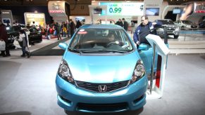 A blue Honda Fit on display at an auto show