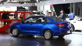 A blue Kia Rio on display at an auto show