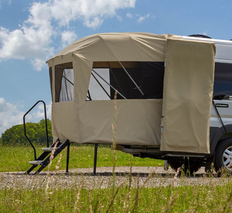 The rear of an RV has a porch tent platform.