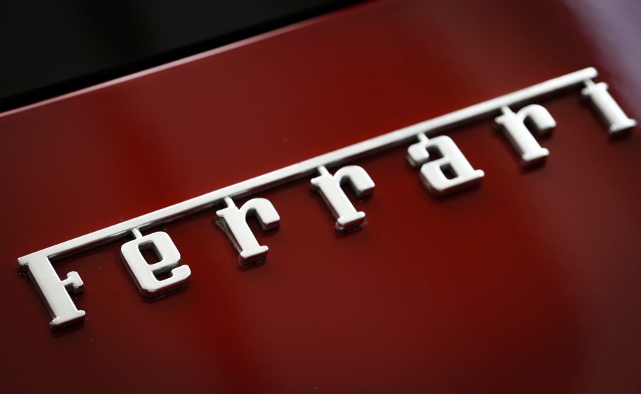 A photo shows the badging of a red Ferrari