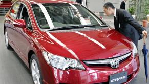 A car shopper inspecting a Honda Civic