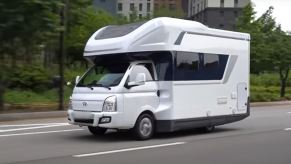 A white Hyundai Porest traveling on the road.