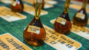 Samples of motor oil displayed on a table with Russian labels