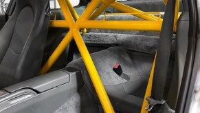 A yellow 4-point roll cage installed in a Porsche 911