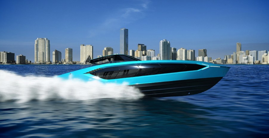 Blue Tecnomar by Lamborghini 63 yacht cutting through the water in front of a city