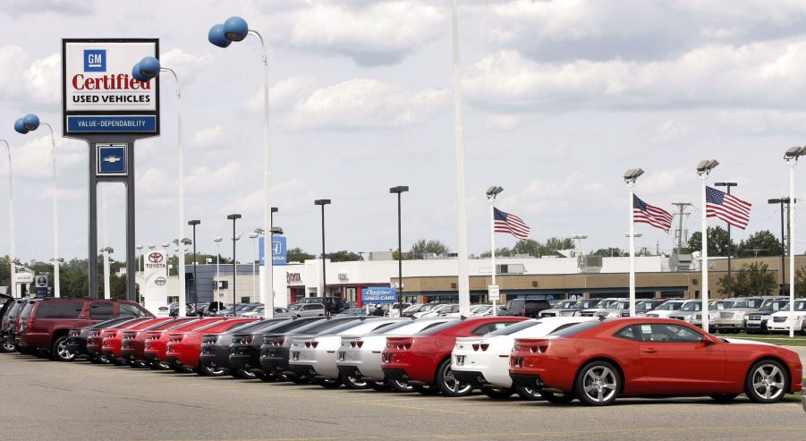 A line of cars at a used car dealership