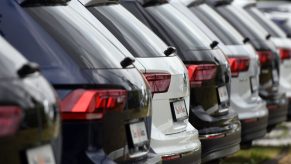 A line of VW SUVs at a dealership.