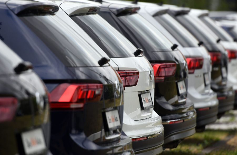 A line of VW SUVs at a dealership.