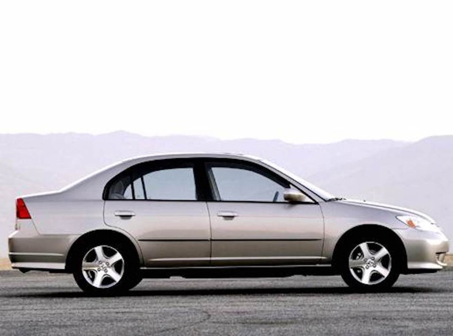 sideview of a beige Honda Civic 2004 model year with mountains in the background