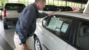 A man looks at a window sticker while shopping.