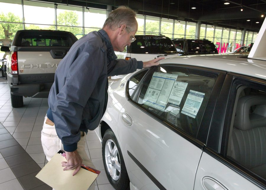 A man looks at a window sticker while shopping.