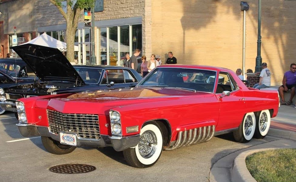 red six-wheel 1970s cadillac