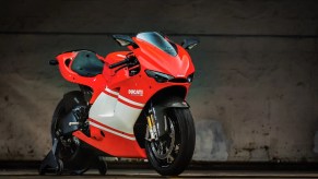 A red-with-white-stripe 2008 Ducati Desmosedici RR on a rear wheel stand