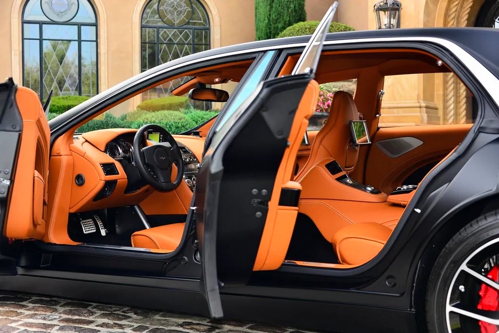 The tan-leather interior of a 2018 Aston Martin Lagonda Taraf seen through its open doors