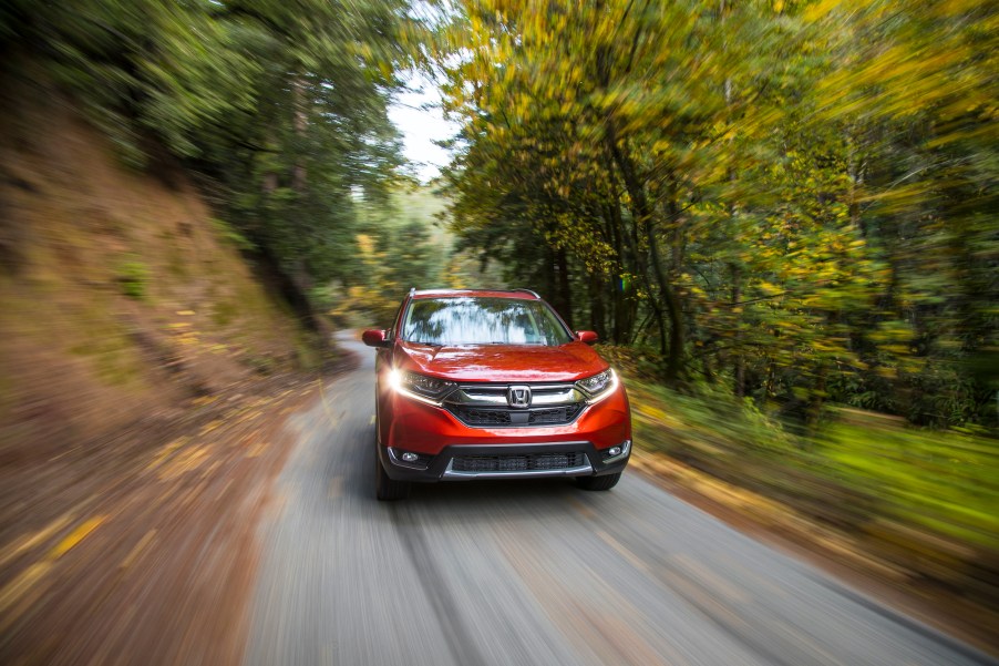 A red 2018 Honda CR-V driving down the countryside.