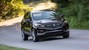 2020 Buick Enclave Avenir driving through a forest