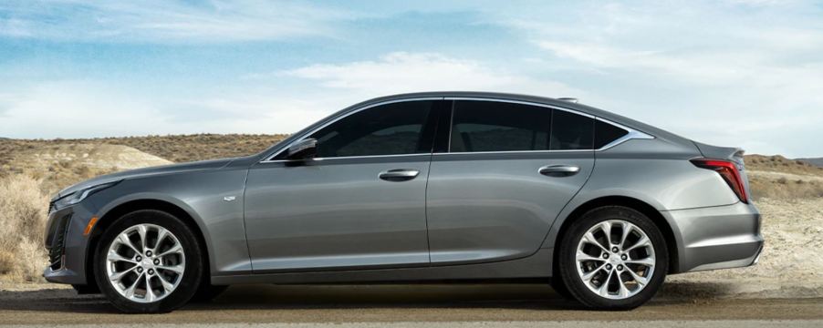 A charcoal colored Cadillac CT5 sedan on a desert road.