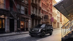 2020 Cadillac Escalade Sport Edition in the city parked next to an apartment building