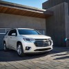 2020 Chevrolet Traverse parked outside a house with a family excited to get into the SUV