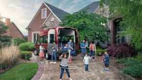 2020 Ford Transit outside of a home with kids playing