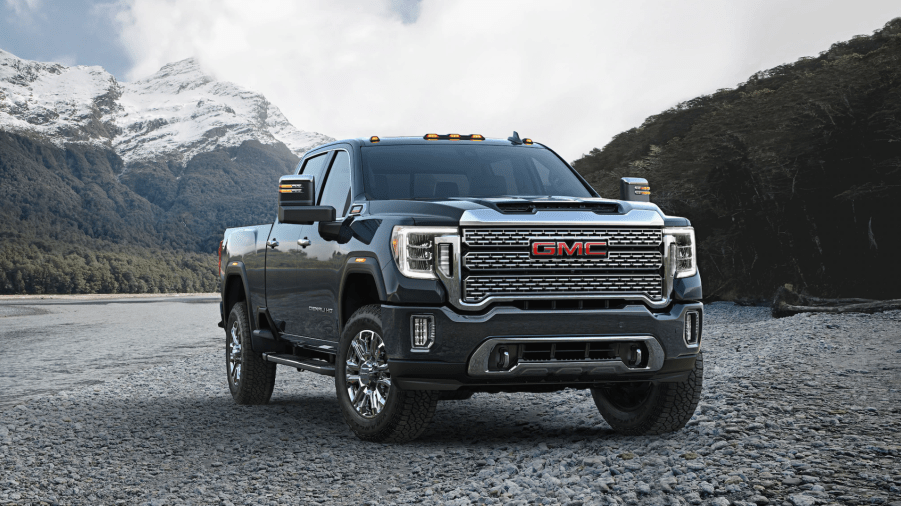 a gray GMC Sierra Denali parked in a gravel yard