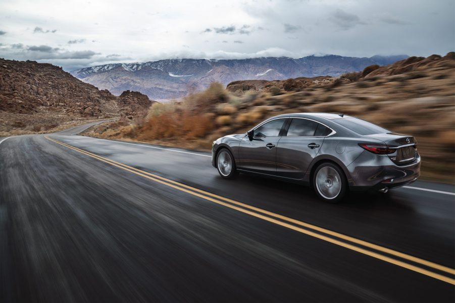 the Japanese Mazda6 at speed on a scenic road