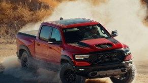 A red 2021 Ram 1500 TRX slides through the desert in a big dust cloud