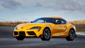 A yellow 2021 Toyota Supra 2.0 parked on a racetrack