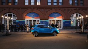 A blue Ford EcoSport parked outside a building