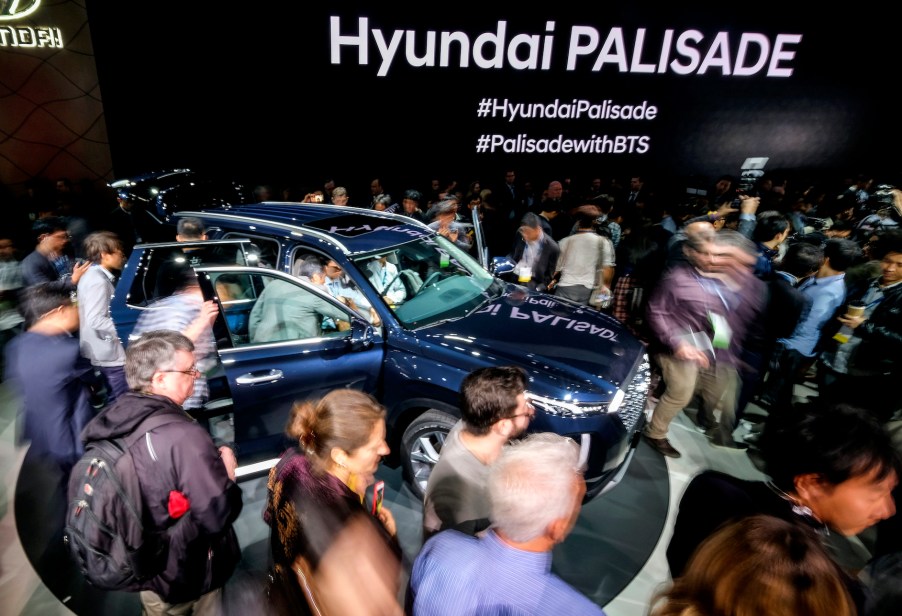 Attendees look at the 2019 Hyundai Palisade SUV during the media preview at the 2018 Los Angeles Auto show