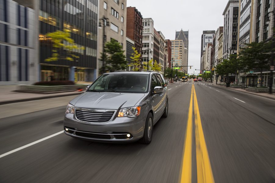 a 2015 silver town and country driving in the city. This is one of the best used minivans to buy.