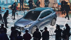 This photo taken on April 3, 2019 shows photographers taking photos of a new Ford Escape car during a press conference in Shanghai