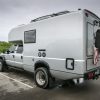 A custom Ford F-550 camper parked at a camp site