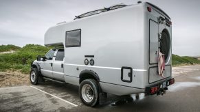 A custom Ford F-550 camper parked at a camp site