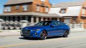 Genesis G70 driving through a city