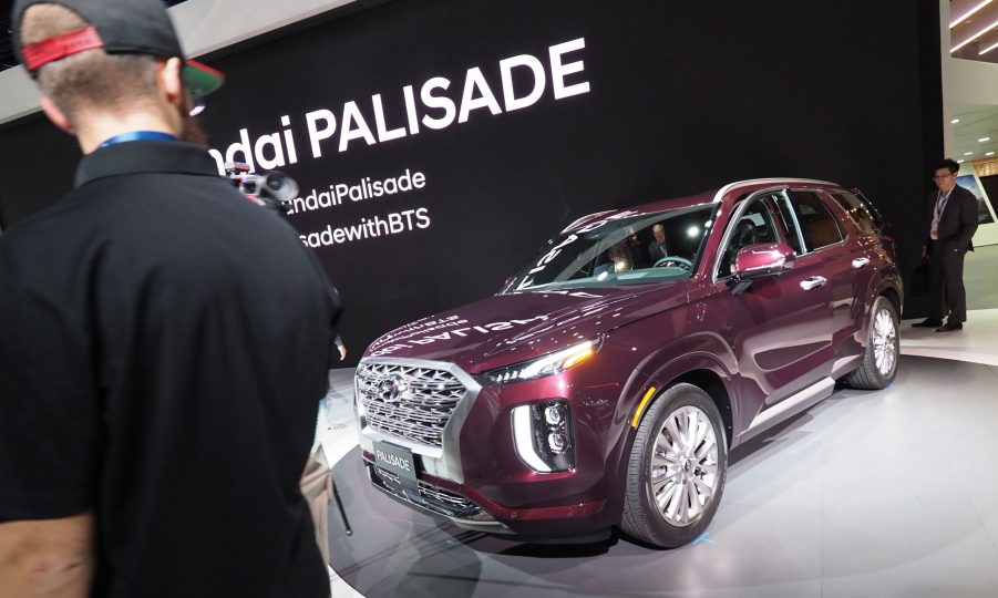 People checking out a new Hyundai Palisade at an auto show