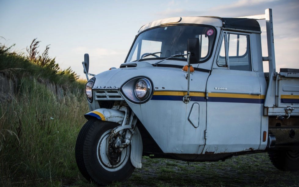 A Mazda T200 press photo in a field 