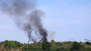 Fire and smoke arise from a motorcycle stunt that went wrong on the set of Mission Impossible 7.