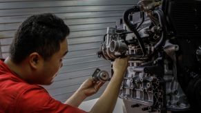 Mechanic tunes up an old Hyundai Galloper engine