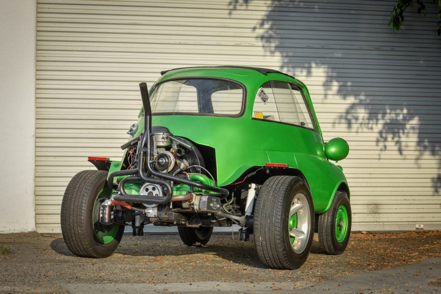 The rear view of a green modified 1957 BMW Isetta, showing the Volkswagen Beetle engine and subframe