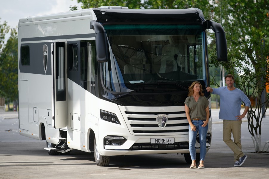 Two models are standing in front of the Morelo Palace 90 SE motorhome RV