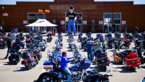 A motorcycle rider looks for a parking spot outside the Full Throttle Saloon during the 80th Annual Sturgis Rally