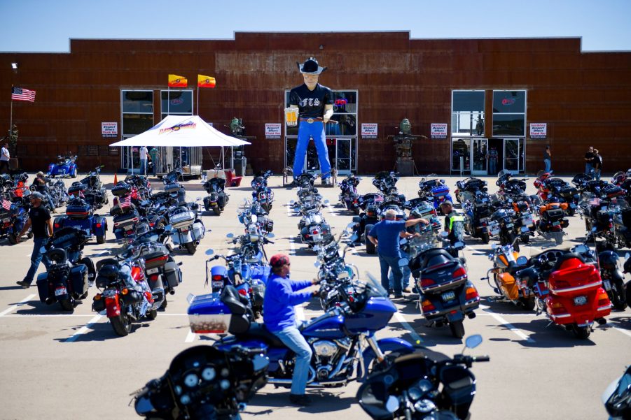 A motorcycle rider looks for a parking spot outside the Full Throttle Saloon during the 80th Annual Sturgis Rally