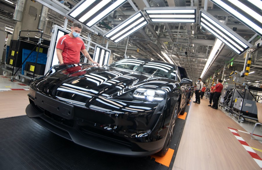 An employee of Porsche AG wears a mouthguard in the production of the battery electric driven sports car Porsche Taycan