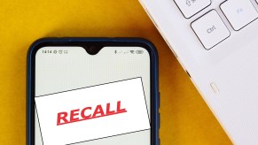 The word, RECALL, is displayed on a smartphone.