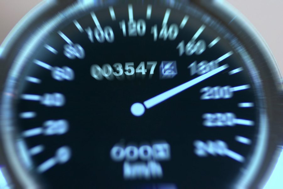 A speedometer shows the needle near 200 kph.