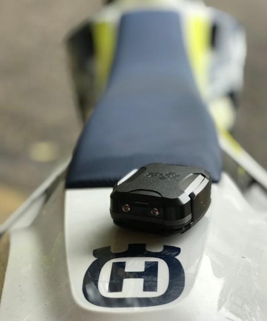 A black Spot Trace motorcycle tracker on a Husqvarna enduro bike