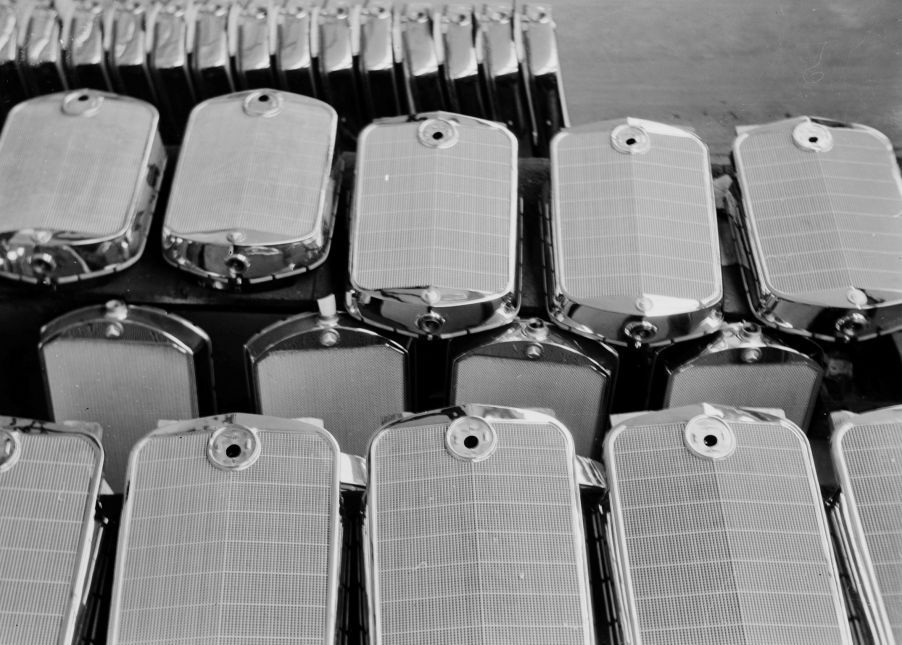 Stacks of car radiators with their grilles on a factor floor