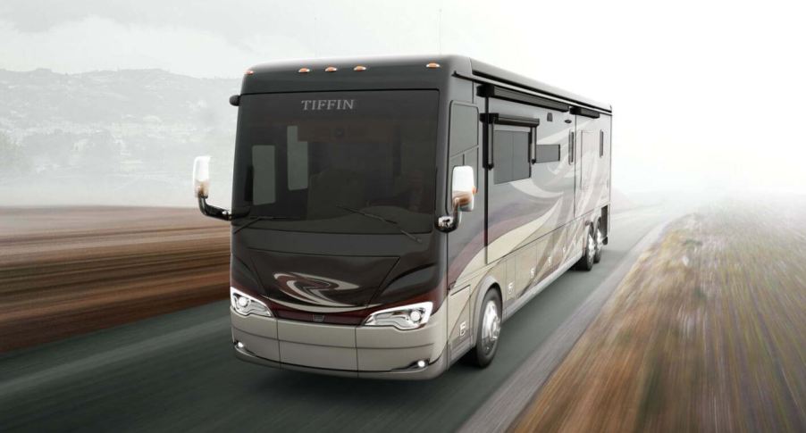 A large bus-like motorhome driving down the roadway.